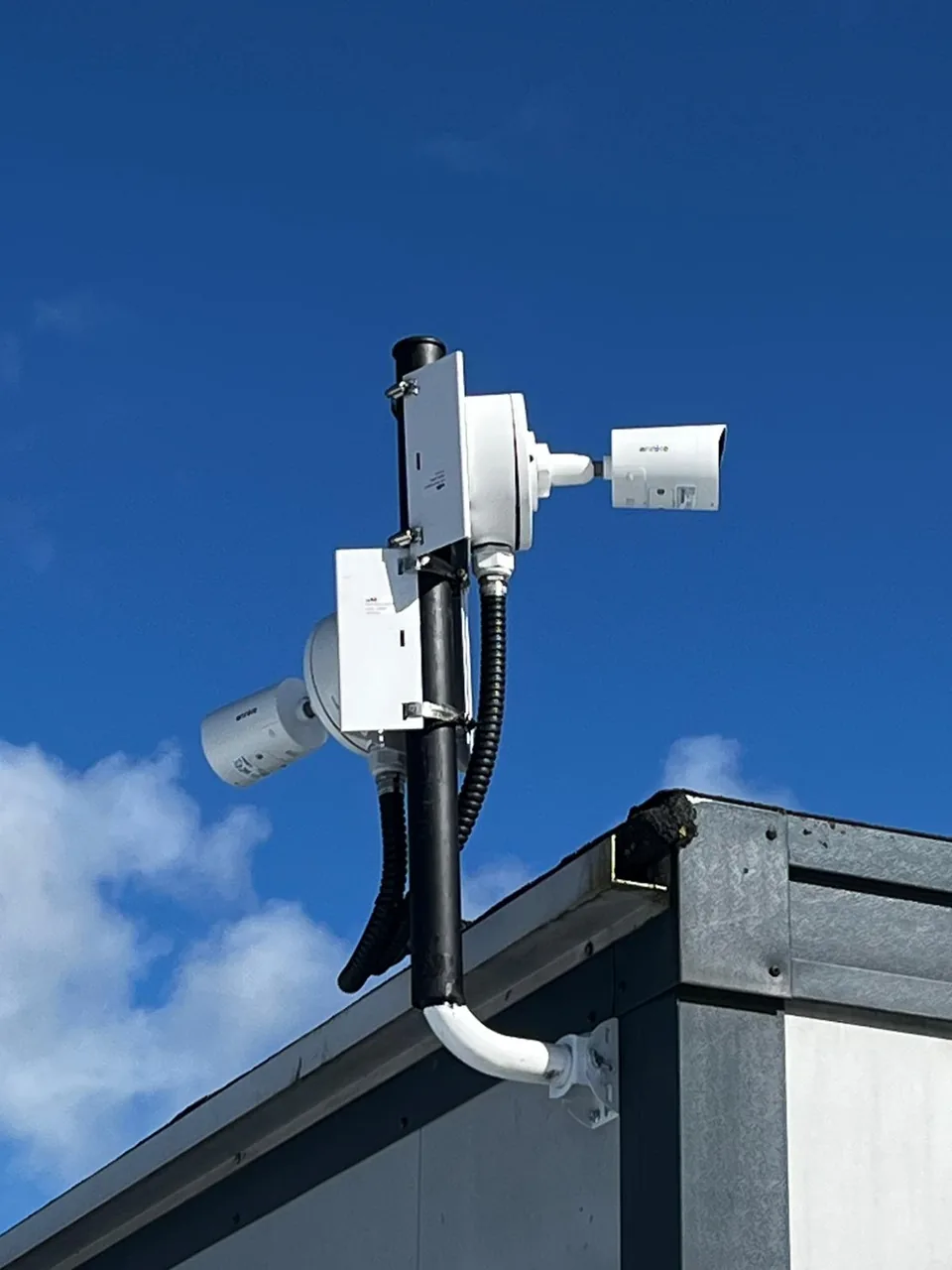 Pole-mounted outdoor CCTV cameras with protected cable connections